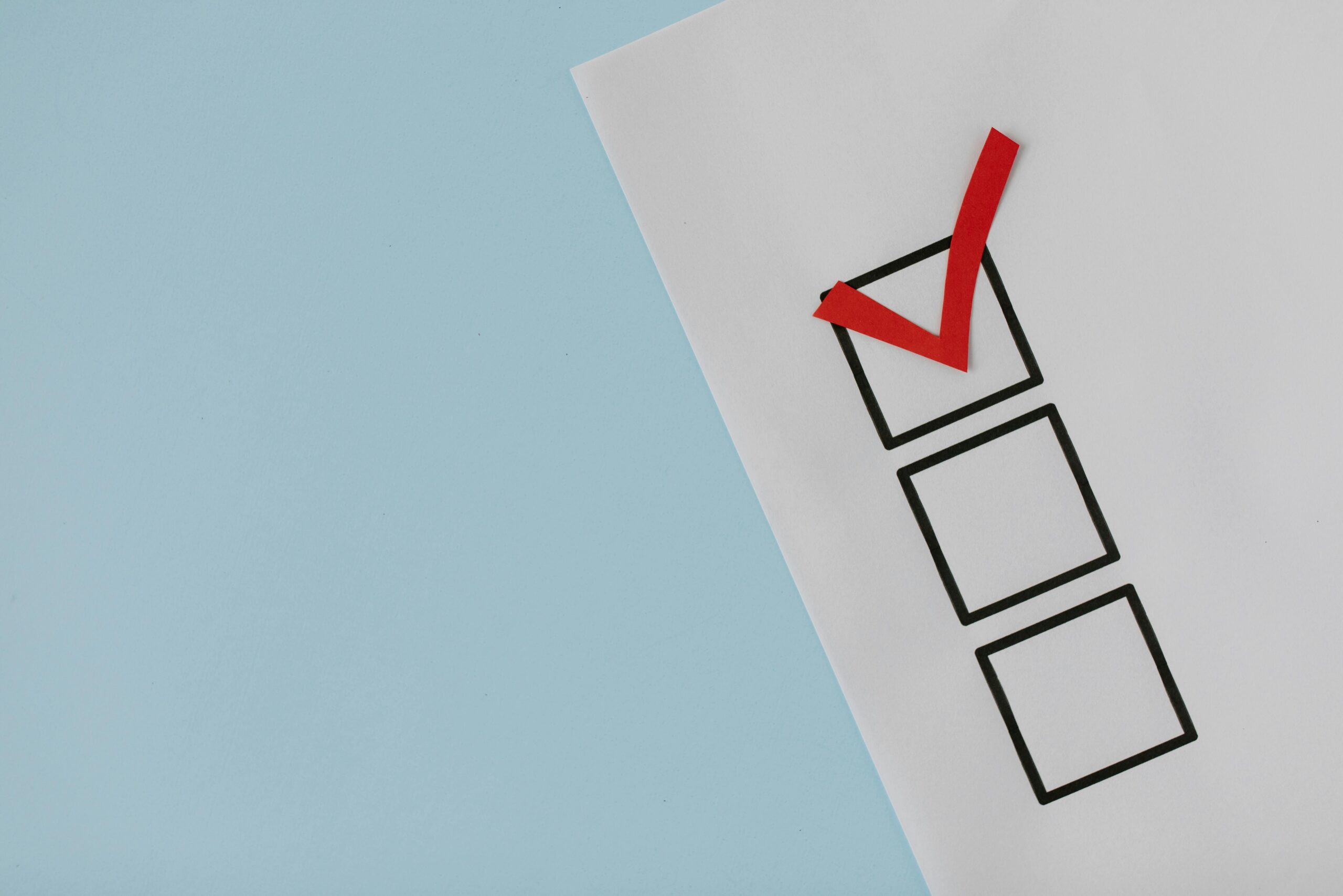 our-services-02 A simple white paper checklist with one red checkmark, ideal for concepts like completion or approval.